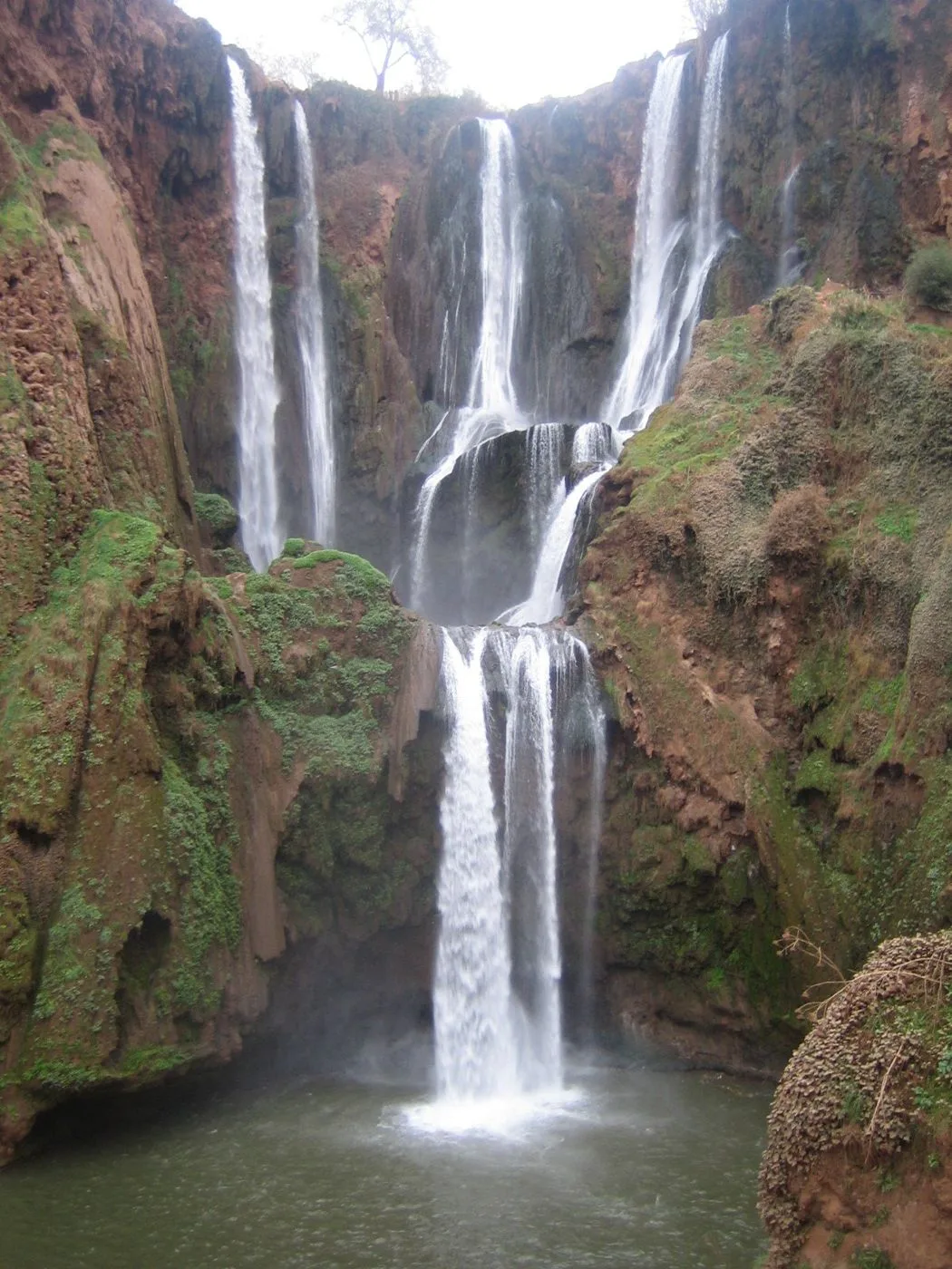 Ouzoud waterfalls descending into a green gorge