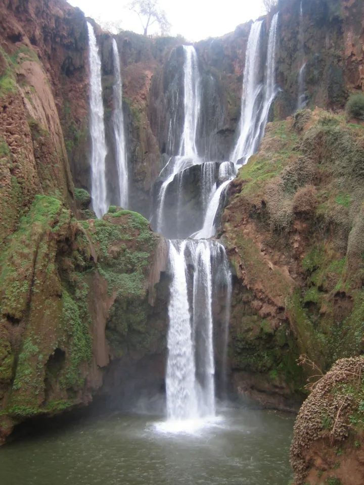 Ouzoud waterfalls descending into a green gorge