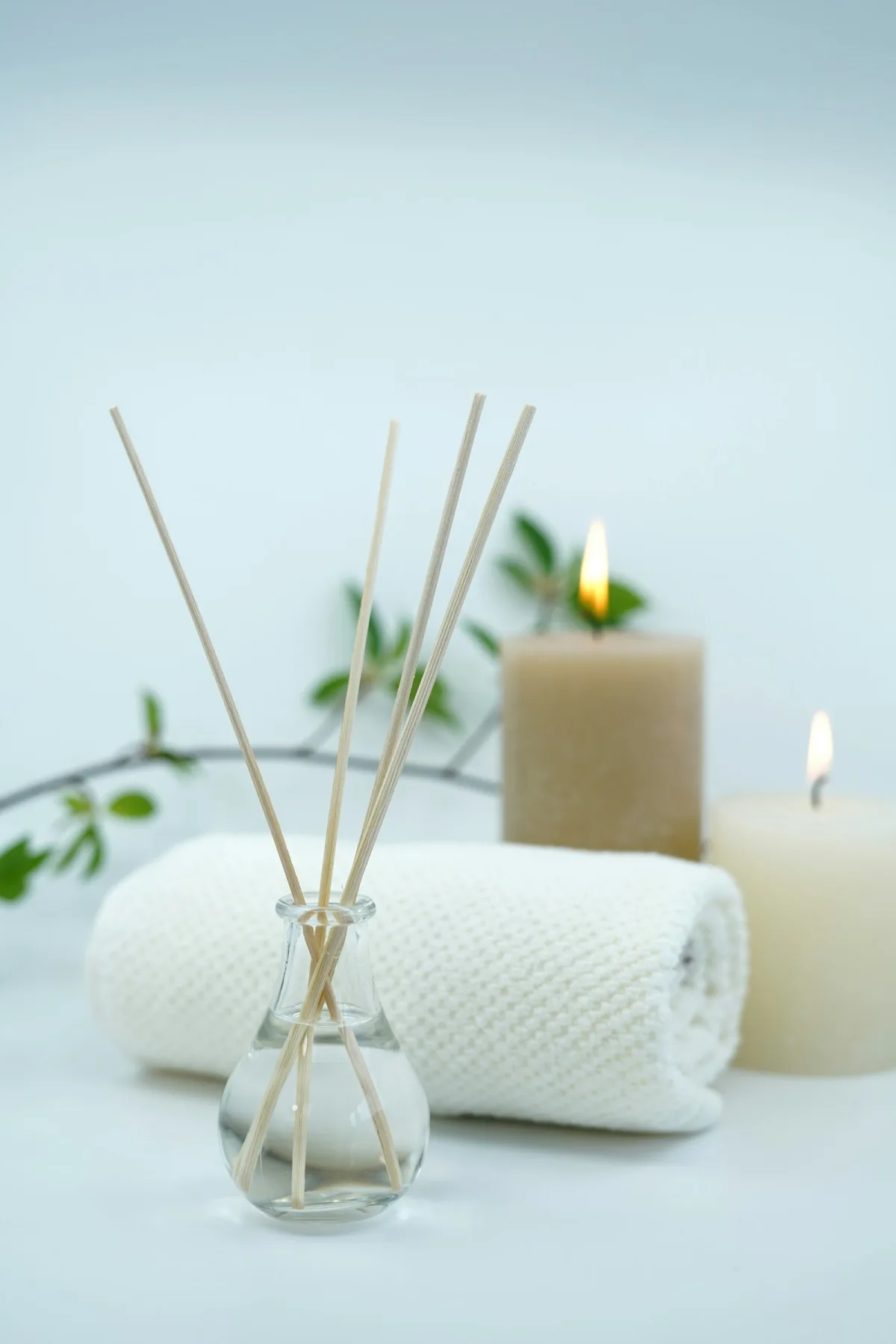 Spa towels, candles and diffuser arranged for relaxation